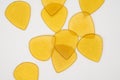 Transparent yellow plastic guitar picks isolated on white Royalty Free Stock Photo