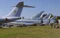 Transport aircrafts and light planes parked in the park of the air show.