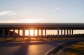 Transport bridge at a road junction for unloading traffic on the road, evening, sunset, copy space Royalty Free Stock Photo