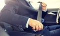 Senior businessman fastening car seat belt