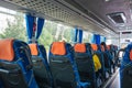 Transport, car travel, tourism and equipment concept - tourist salon and bus places. People are sitting in the cabin. Royalty Free Stock Photo