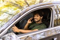 transport, communication and people concept. Indian man or driver driving car and calling on smartphone