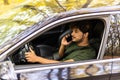 transport, communication and people concept - smiling indian man or driver driving car and calling on phone