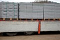 Transport of concrete bricks with for house foundations or fencing. pallets with gray bricks are unloaded from the body of the car