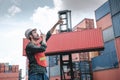 Transport Container Engineer Managing Control Via Walkie Talkie in Containers Shipyard. Container Logistics Shipping Management of Royalty Free Stock Photo