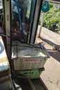 Transport of fresh tofu. Plastic boxes with fresh tofu, transported in a passengers bus with open doors. Mawlamyine, Myanmar,