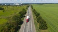 Transport logistics background. Commercial truck and cars driving by the highway. View above Royalty Free Stock Photo