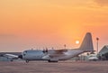 Transport military cargo aircraft parked standby ready to takeoff on sunset time Royalty Free Stock Photo