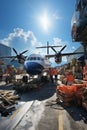 Transport plane at the airport. Workers load goods and cargo onto the plane. Cargo pallets. Air freight