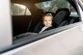 Transport, safety, childhood road trip and people concept. Happy Caucasian cute little baby girl sitting in baby car Royalty Free Stock Photo