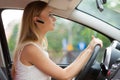 Woman driving car with headset Royalty Free Stock Photo