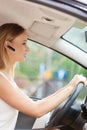 Woman driving car with headset Royalty Free Stock Photo