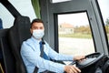 Driver in medical mask driving intercity bus