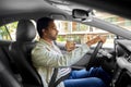 indian man or driver with coffee driving car