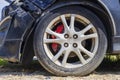 Close up tire after front black car damaged and broken by accident on road Royalty Free Stock Photo