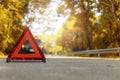 Red triangle, red emergency stop sign, red emergency symbol and black car stop and park on road Royalty Free Stock Photo