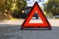 Red triangle, red emergency stop sign, red emergency symbol and black car stop and park on road