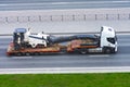 Transportation of equipment for cutting and removing old asphalt pavement for road repair on a truck platform of a truck trailer