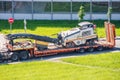 Transportation of equipment for cutting and removing old asphalt pavement for road repair on a truck platform of a truck trailer