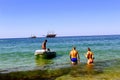 Transportation of a group of people on a white inflatable rubber boat with a motor