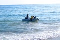 Transportation of a group of people on a white inflatable rubber boat with a motor