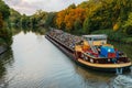 Transportation industry. Ship barge transports scrap metal and sand with gravel. Barge loaded with scrap metal is on the Royalty Free Stock Photo