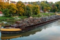 Transportation industry. Ship barge transports scrap metal and sand with gravel. Barge loaded with scrap metal is on the Royalty Free Stock Photo