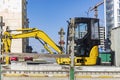 Transportation of a mini excavator to a construction site in a truck. Compact excavator for earthworks Royalty Free Stock Photo