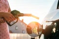 Transportation and ownership concept - woman pumping gasoline fuel in car at gas station Royalty Free Stock Photo