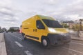 Transportation service with a yellow van moving fast on the road