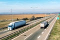 Transportation trucks passing by on asphalt highway Royalty Free Stock Photo