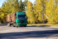 Transportation in trucks with special semi-trailers of forest logs. Transportation of timber and firewood on country roads,