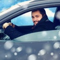 Transportation, winter and people concept - happy smiling man driver behind the wheel his car