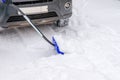 Transportation, winter, people and vehicle concept - closeup of man digging snow with shovel near car Royalty Free Stock Photo