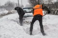 Transportation, winter, people and vehicle concept - closeup of man digging snow with shovel near car Royalty Free Stock Photo