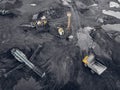 Transporting coal on yellow large dump truck. Open pit mine industry Top aerial view
