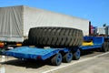 Transporting a large wheel for a mining truck on a truck trailer. The protector of a large rubber wheel.