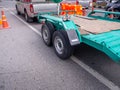 Transporting small cargo trailer for a car strapped