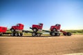 Transporting three new red trucks Royalty Free Stock Photo
