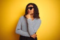 Transsexual transgender woman wearing sunglasses over isolated yellow background with hand on chin thinking about question, Royalty Free Stock Photo