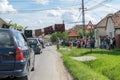 TRANSYLVANIA REGION, ROMANIA - 10 JUNE, 2017: Romanian wedding tradition. Locals allowing cars to pass after groom and bride pays