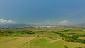 Transylvanian landscape with green meadows and city and mountains in the background