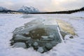 Trapped methane bubbles frozen into the water under the thick cracked and folded ice on Abraham Lake, located in the Kootenay Royalty Free Stock Photo