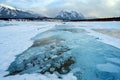 Trapped methane bubbles frozen into the water under the thick cracked and folded ice on Abraham Lake, located in the Kootenay Royalty Free Stock Photo