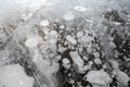 Trapped methane bubbles frozen into the water under the thick cracked and folded ice on Abraham Lake, located in the Kootenay Royalty Free Stock Photo