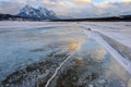 Trapped methane bubbles frozen into the water under the thick cracked and folded ice on Abraham Lake, located in the Kootenay Royalty Free Stock Photo