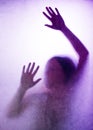 Trapped woman, back lit silhouette of hands behind matte glass Royalty Free Stock Photo