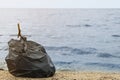 Trash bag full of garbage on beach. Space for text Royalty Free Stock Photo