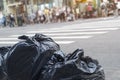 Trash bags on city street sideways tilt sunset.