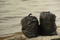 Trash bags full of garbage on beach Royalty Free Stock Photo